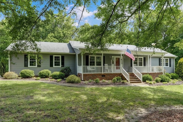 ranch-style home with covered porch and a front yard