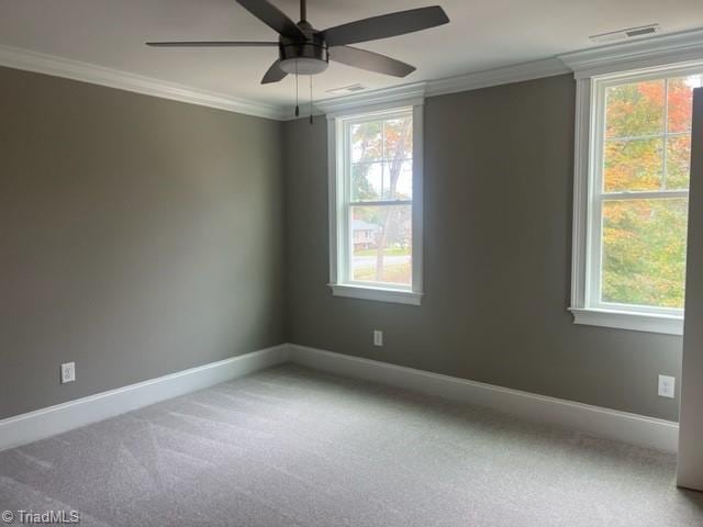 unfurnished room featuring ornamental molding, carpet, and ceiling fan