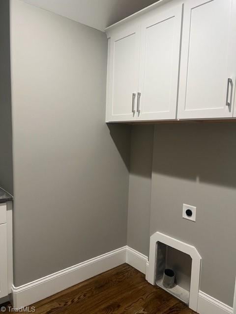 washroom with cabinets, dark wood-type flooring, and electric dryer hookup