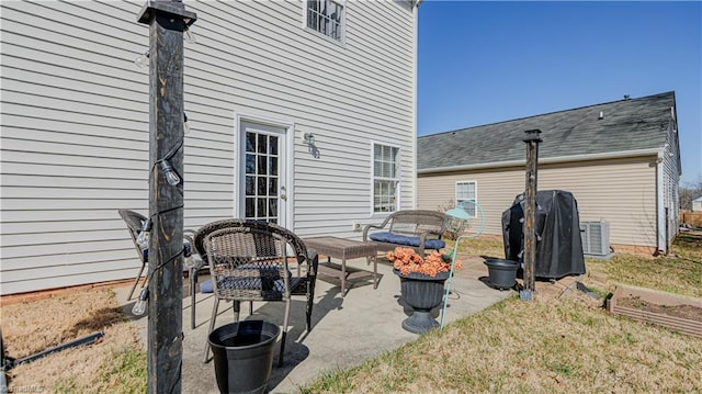 view of patio / terrace with central AC unit and a grill