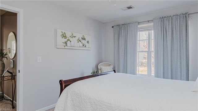 bedroom featuring visible vents and baseboards