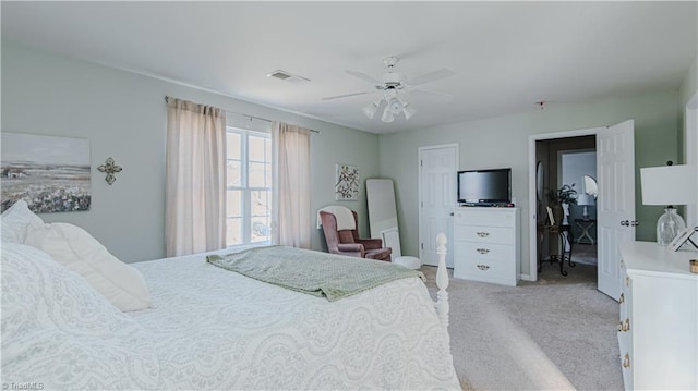 bedroom featuring ceiling fan, visible vents, and light carpet