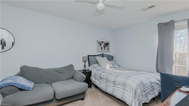 bedroom with carpet flooring, a ceiling fan, and visible vents