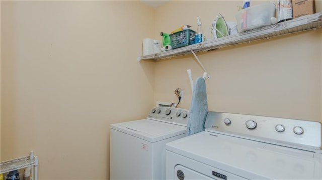 washroom featuring laundry area and washing machine and dryer