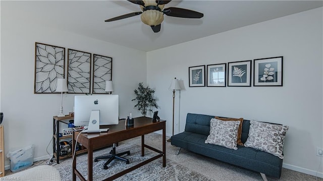 home office featuring carpet flooring, baseboards, and ceiling fan