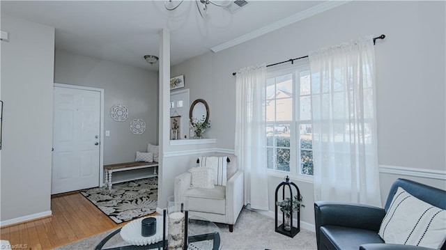 living area featuring visible vents, baseboards, and wood finished floors