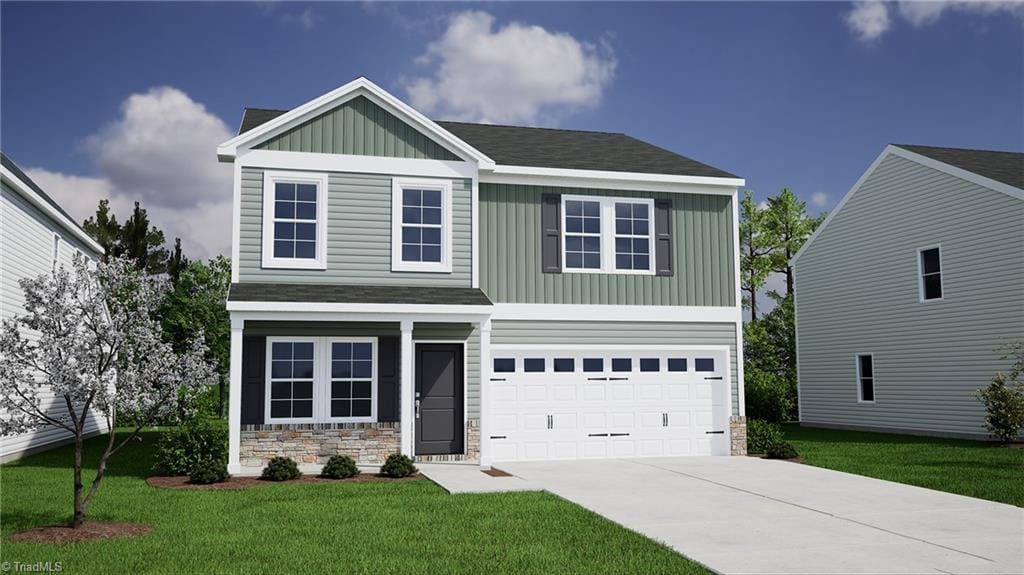 craftsman house featuring a front yard and a garage