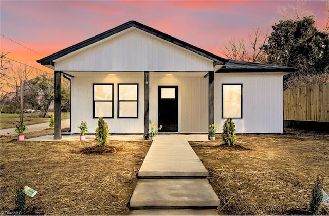 view of front of house featuring fence