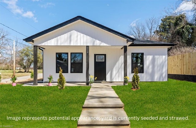 modern farmhouse style home featuring a front lawn and fence