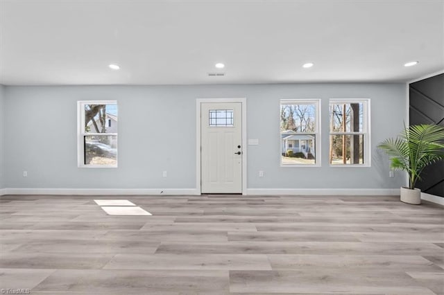 foyer featuring light wood-type flooring, visible vents, baseboards, and recessed lighting