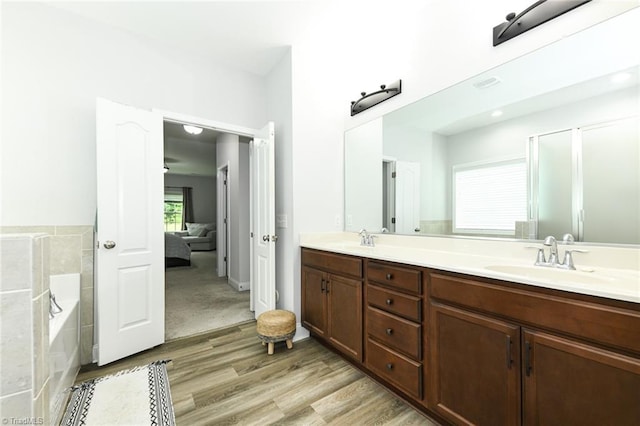 1117 Magenta Way, Kernersville, NC 27284 - ensuite bathroom featuring wood finished floors, double vanity, a bath, and a shower with shower door