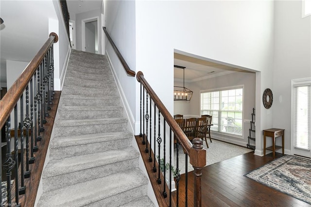 1117 Magenta Way, Kernersville, NC 27284 - staircase featuring hardwood / wood-style flooring, a chandelier, and baseboards