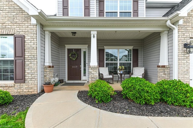 1117 Magenta Way, Kernersville, NC 27284 - view of exterior entry featuring a porch and brick siding
