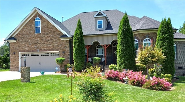 view of front of property with a front lawn, a garage, and a porch