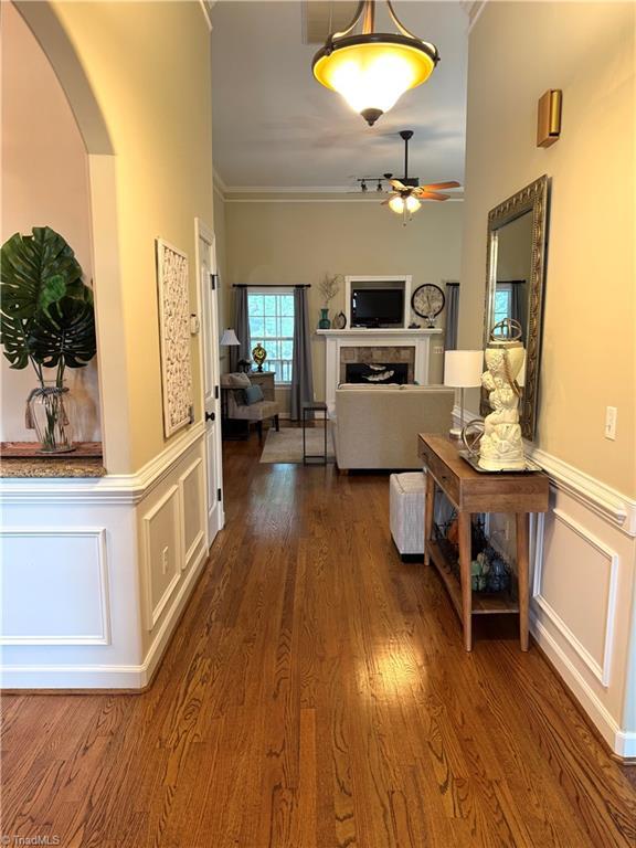 hall featuring dark hardwood / wood-style floors and ornamental molding