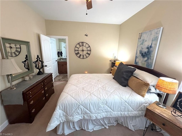 carpeted bedroom with ceiling fan and ensuite bath