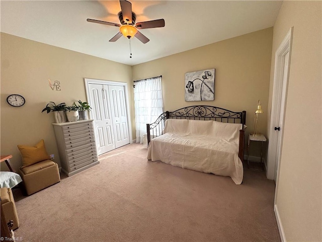 carpeted bedroom featuring a closet and ceiling fan