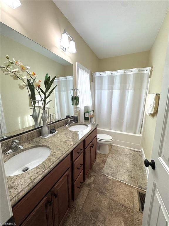 full bathroom featuring toilet, vanity, and shower / bath combination with curtain