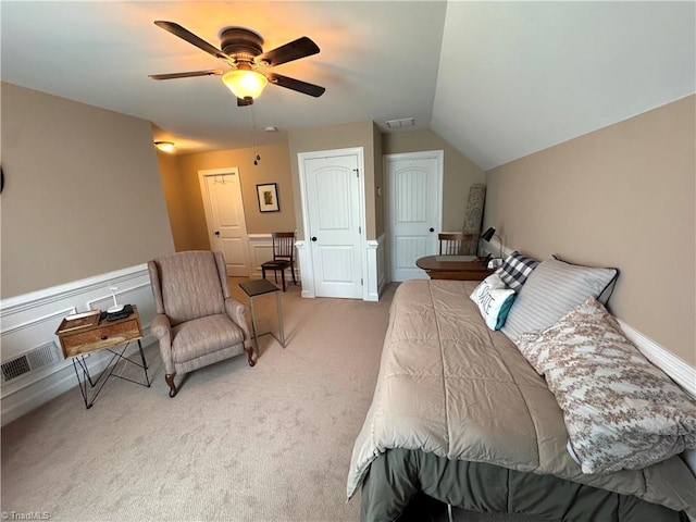 carpeted bedroom with ceiling fan and vaulted ceiling