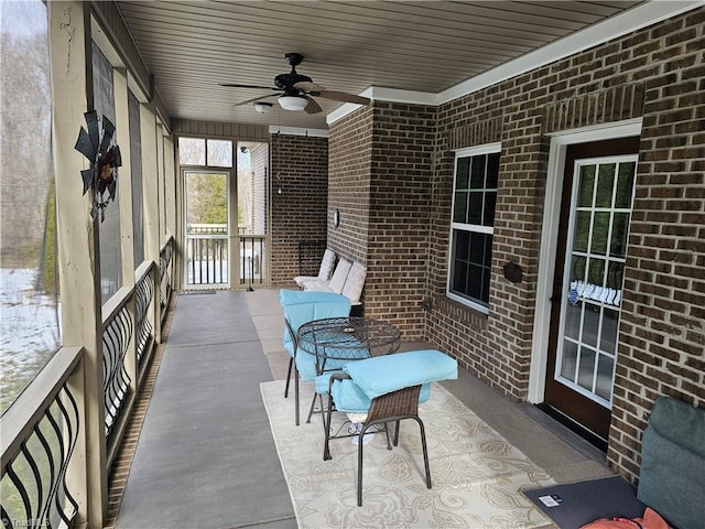 sunroom / solarium featuring ceiling fan