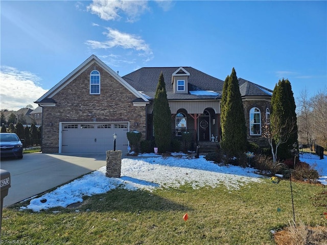 view of front of home with a garage and a front lawn