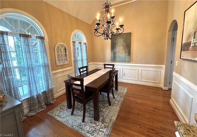 dining room featuring vaulted ceiling, dark hardwood / wood-style floors, and an inviting chandelier