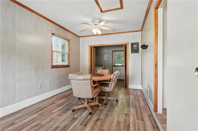 827 Woodcote Dr, Winston-Salem, NC 27107 - dining room with crown molding, wood finished floors, a textured ceiling, wood walls, and ceiling fan