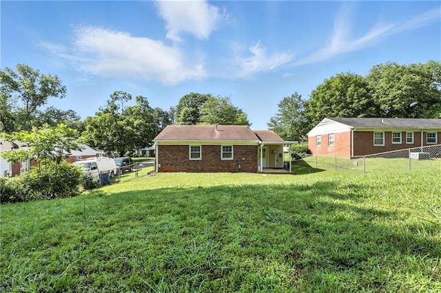 827 Woodcote Dr, Winston-Salem, NC 27107 - rear view of house with brick siding and a fenced backyard