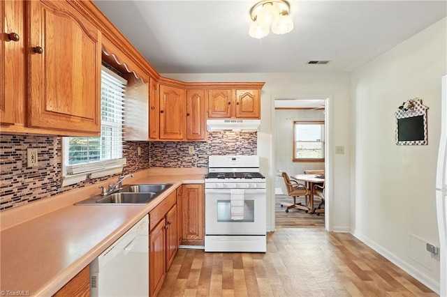 827 Woodcote Dr, Winston-Salem, NC 27107 - kitchen with white appliances, under cabinet range hood, plenty of natural light, and light wood-type flooring