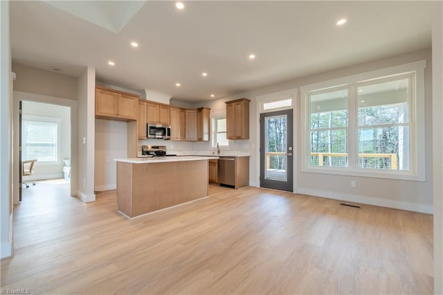 kitchen with light countertops, light wood-style flooring, recessed lighting, and appliances with stainless steel finishes