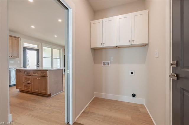 laundry area with baseboards, light wood-type flooring, washer hookup, cabinet space, and electric dryer hookup