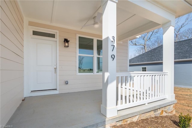 view of exterior entry with a porch and a ceiling fan