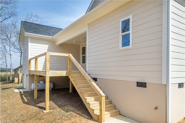 entrance to property featuring crawl space and a shingled roof