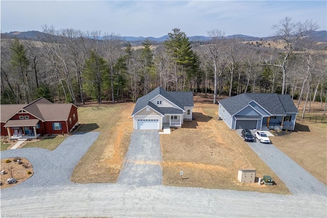 birds eye view of property featuring a view of trees