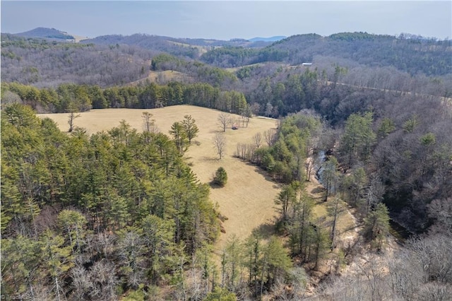 aerial view with a mountain view and a wooded view