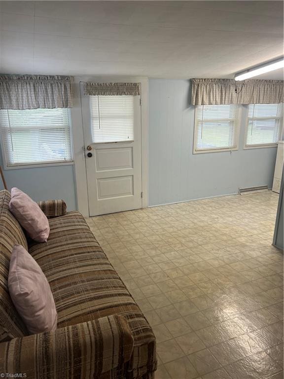 living area featuring light flooring and healthy amount of natural light