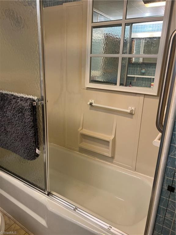full bath with shower / bath combination with glass door