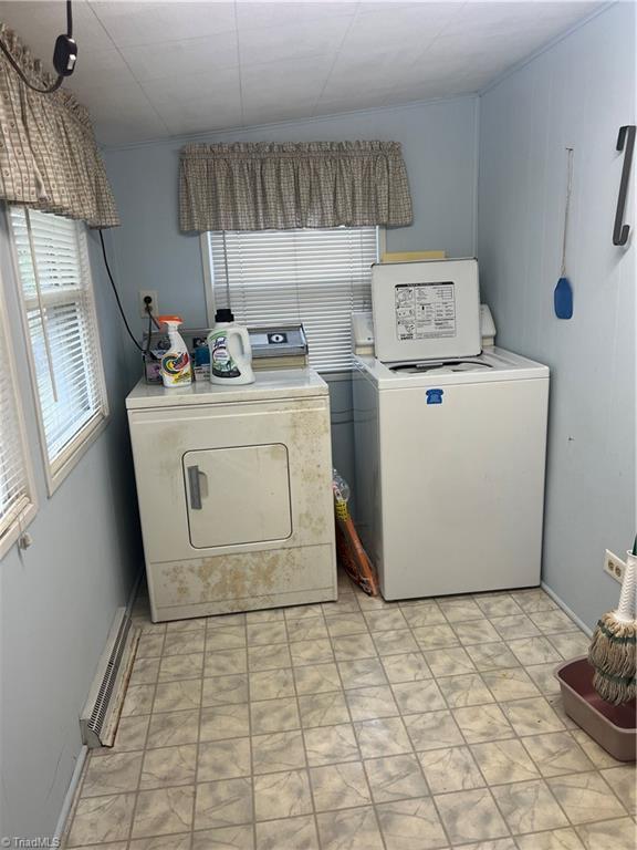 laundry room with separate washer and dryer and light floors