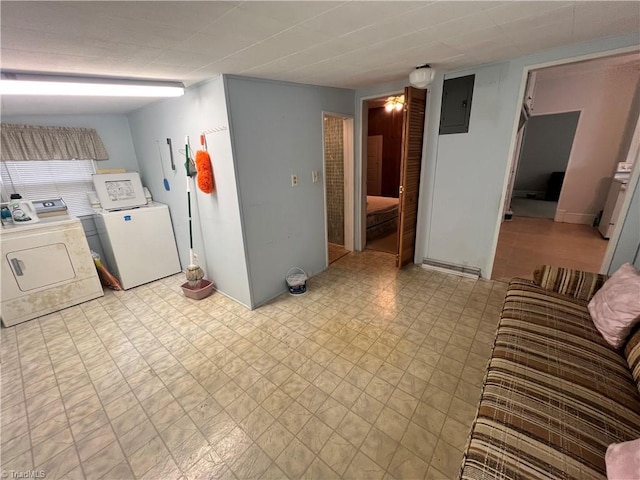 laundry area featuring washer and clothes dryer, light floors, and electric panel