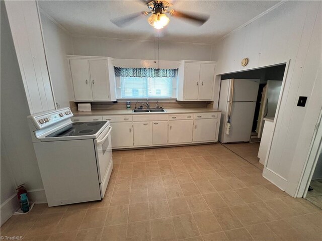 kitchen with white appliances, a sink, ceiling fan, white cabinets, and light countertops