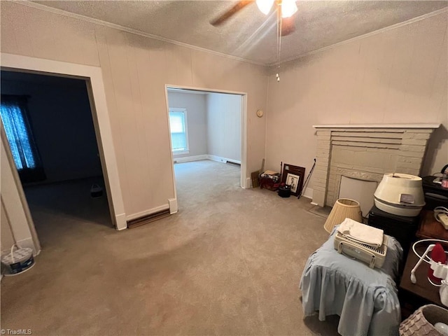 sitting room featuring crown molding, a textured ceiling, a ceiling fan, carpet, and baseboards