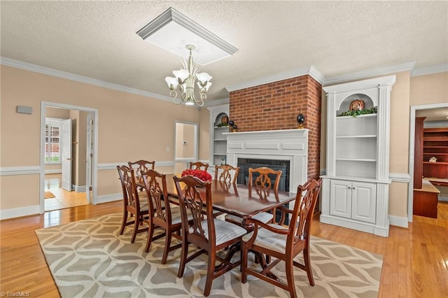 dining space featuring a textured ceiling and light wood-style floors