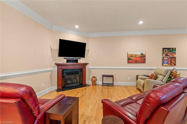 living area with recessed lighting, ornamental molding, a fireplace with flush hearth, and wood finished floors