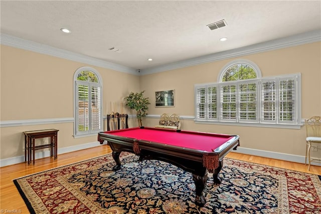 game room featuring visible vents, ornamental molding, pool table, and wood finished floors
