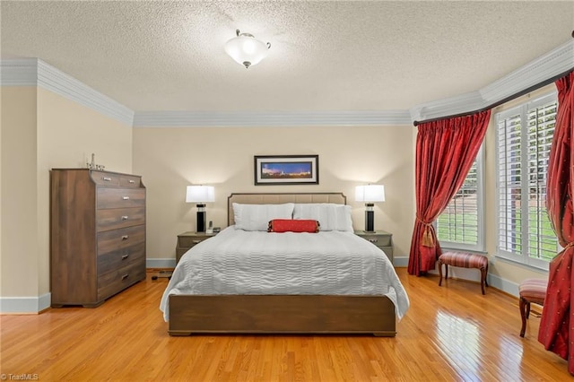 bedroom featuring a textured ceiling, ornamental molding, multiple windows, and wood finished floors