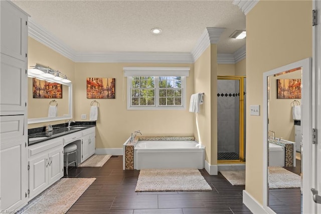 bathroom featuring crown molding, a textured ceiling, a bath, and a shower stall