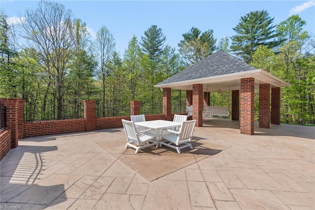 view of patio / terrace featuring outdoor dining area and a gazebo