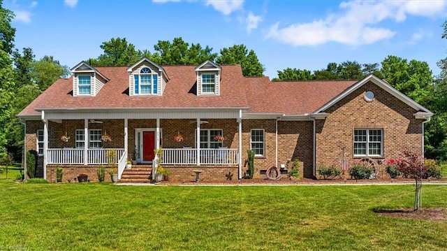 2515 E Woodlyn Way, Greensboro, NC 27407 - cape cod-style house featuring a front yard, a porch, and brick siding
