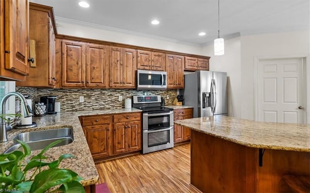 2515 E Woodlyn Way, Greensboro, NC 27407 - kitchen featuring stainless steel appliances, a sink, ornamental molding, tasteful backsplash, and brown cabinets