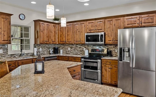 2515 E Woodlyn Way, Greensboro, NC 27407 - kitchen with appliances with stainless steel finishes, brown cabinets, light stone counters, ornamental molding, and recessed lighting